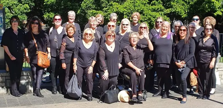 Lady in a wheelchair with her Choir called the sing Sisters